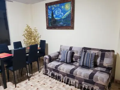 a living room with a couch and a table with chairs at Carosvi Home in Lima