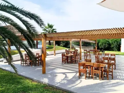 a group of tables and chairs under a pavilion at Casa entera con piscina y salida a la playa in Salinas