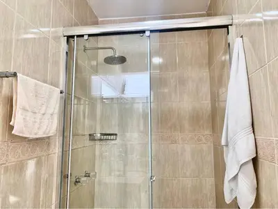a shower with a glass door in a bathroom at Casa entera con piscina y salida a la playa in Salinas