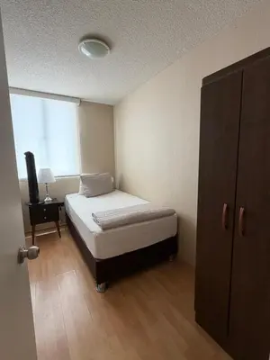 a small bedroom with a bed and a window at dos apartamentos cerca de la laguna de Huacachina in Ica