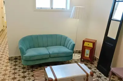 a blue couch in a living room with a table at Departamento boutique in Lima