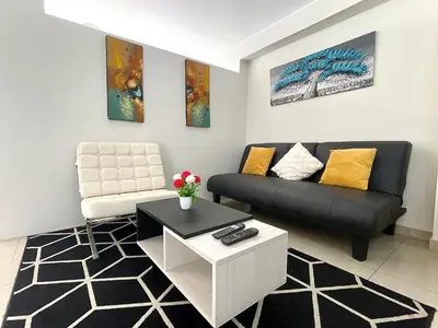 a living room with a couch and a chair at Departamento con vista de Lima in Lima