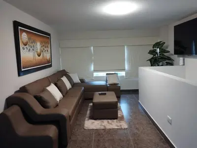 a living room with a couch and a table at Mini Apartamento, cerca al Malecón de Chorrillos in Lima
