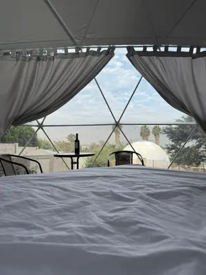 a white bed in a tent with a view at Amaya Experience in Miraflores