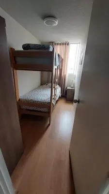 a small room with two bunk beds and a hallway at Apartamento Varela 3 dormitorios in Lima