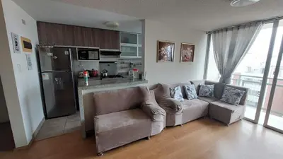 a living room with a couch and a kitchen at Apartamento Varela 3 dormitorios in Lima