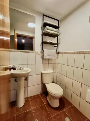 a bathroom with a toilet and a sink at Casa Pardo in Cusco