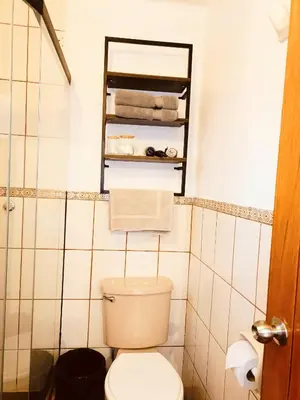 a small bathroom with a toilet and towels at Casa Pardo in Cusco