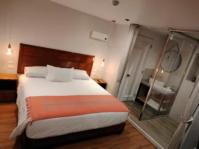 a bedroom with a large bed and a mirror at Casa Cruz Verde by Peru Garden Hotels in Cusco