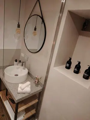 a bathroom with a sink and a mirror and a shower at Casa Cruz Verde by Peru Garden Hotels in Cusco