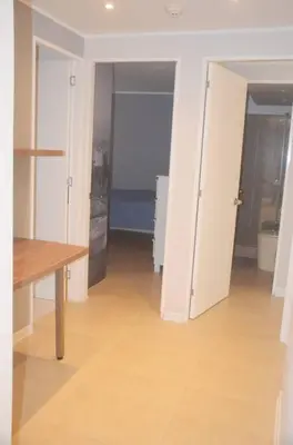 a room with a hallway with white doors and a table at Super céntrico y Hermoso Muy cerca a INEN in Lima