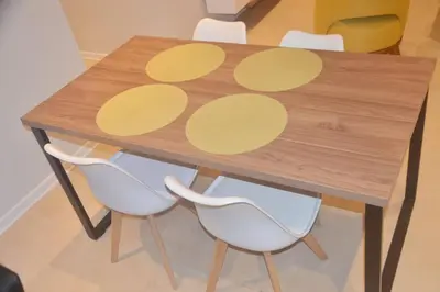 a wooden table with white chairs around it at Super céntrico y Hermoso Muy cerca a INEN in Lima