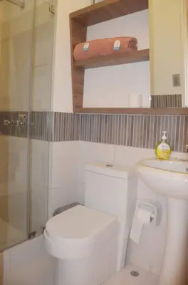 a white bathroom with a toilet and a shower at Super céntrico y Hermoso Muy cerca a INEN in Lima