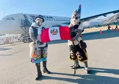 two people in costumes standing in front of an airplane at Hospedaje Mónaco - Jauja Airport in Jauja