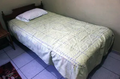 a bed in a bedroom with a pillow on it at Departamento Completo en San Luis - Complete Apartment in San Luis in Lima