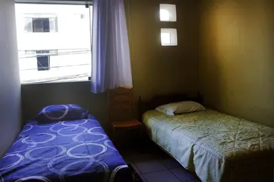 a small bedroom with a bed and a window at Departamento Completo en San Luis - Complete Apartment in San Luis in Lima