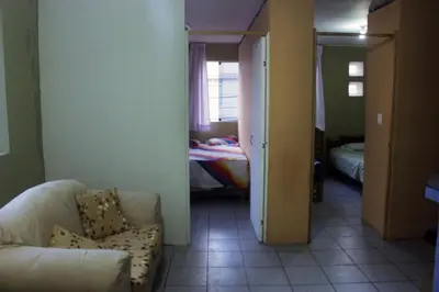a living room with a couch and a bedroom at Departamento Completo en San Luis - Complete Apartment in San Luis in Lima
