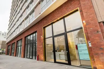 a brick building with large windows on the side of it at Great view and Pool apartment in Lima