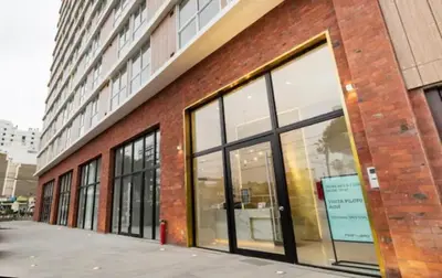 a brick building with large windows on the side of it at Great view and Pool apartment in Lima