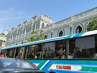 a bus is parked in front of a building at Sai in Lima