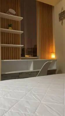 a bedroom with a white bed and a window at Sai in Lima