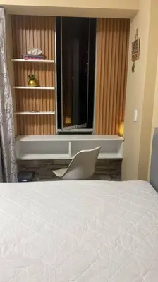 a bedroom with a bed and a window and a chair at Sai in Lima