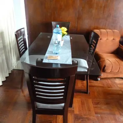 a dining room table with a bottle of water on it at Alquilo Dpto Equipado San Isidro in Lima