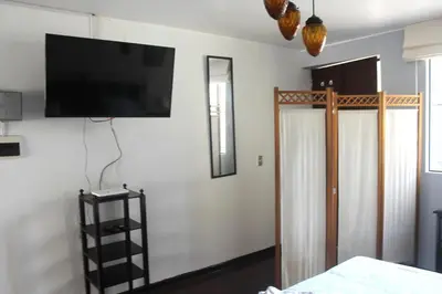 a room with a flat screen tv on a wall at Alquilo Dpto Equipado San Isidro in Lima