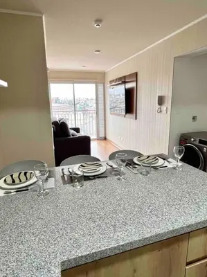 a kitchen with a counter with wine glasses on it at Departamento estrenó céntrico a universidades in Lima