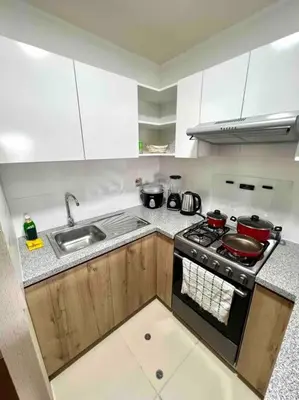 a kitchen with a stove and a sink at Departamento estrenó céntrico a universidades in Lima