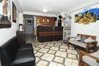 a waiting room with a couch and a table at Casa Medina Hostal in Cusco