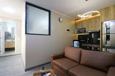 a living room with a couch and a large window at Dasso 167 by Wynwood House in Lima