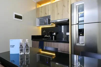 a kitchen with two water bottles on a counter at Dasso 167 by Wynwood House in Lima