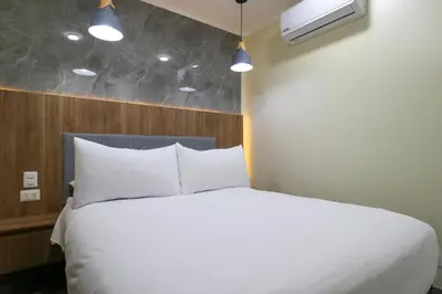 a bedroom with a bed with white pillows at Dasso 167 by Wynwood House in Lima