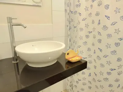 a bathroom with a sink and a shower curtain at Centro Histórico de Lima, Departamentos Temporales in Lima