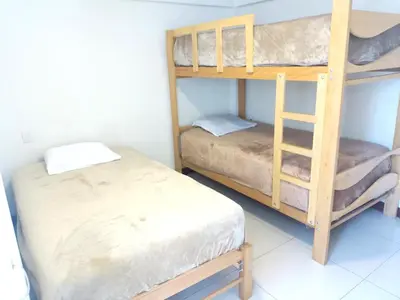 a room with two bunk beds and a bed at Centro Histórico de Lima, Departamentos Temporales in Lima