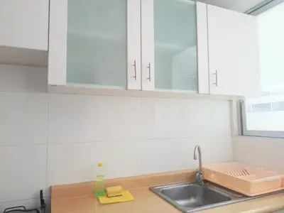 a kitchen with white cabinets and a sink at Centro Histórico de Lima, Departamentos Temporales in Lima