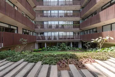 an apartment building with a garden in front of it at Miraflores Centre Boutique Apartment 101B in Lima