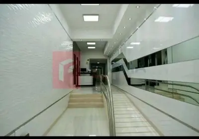a hallway with stairs in a building with a glass wall at Departamentos Céntricos en Lima in Lima