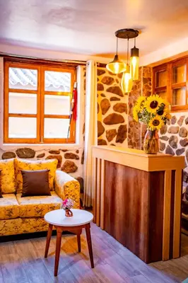 a living room with a couch and a table at NUNA SUMAQ Hotel in Ollantaytambo