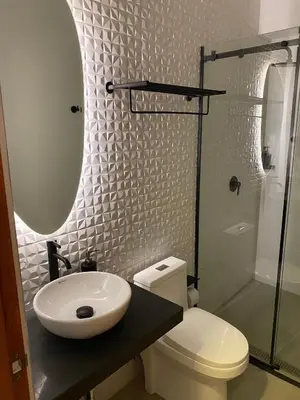 a bathroom with a toilet and a sink and a mirror at Ribera del Rio Club Resort in Cieneguilla