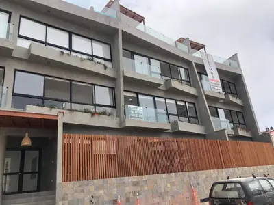 a building with a car parked in front of it at Punta Hermosa in Punta Hermosa
