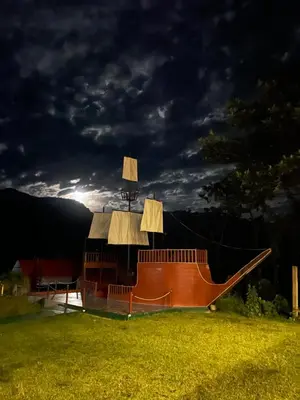 a wooden boat sitting in a field at night at MONTEVERDIA - Hotel & Resort in Pozuzo