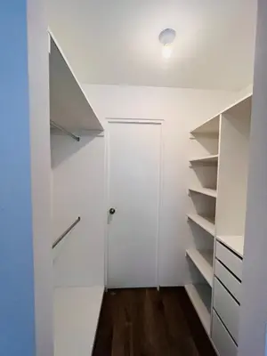 a walk in closet with a door and shelves at MONTERRICO POLO APARTS #17 - Dpto de estreno con Balcón Frente Embajada USA in Lima