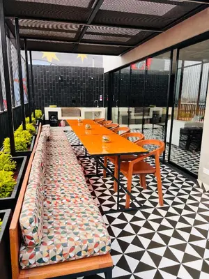 a cafeteria with a table and chairs on a checkered floor at MONTERRICO POLO APARTS #17 - Dpto de estreno con Balcón Frente Embajada USA in Lima