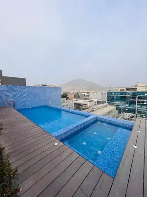 a swimming pool on the roof of a building at MONTERRICO POLO APARTS #17 - Dpto de estreno con Balcón Frente Embajada USA in Lima