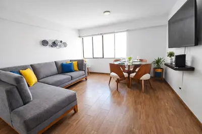 a living room with a couch and a table at Modern 1-Bedroom Apartment with WiFi in Miraflores in Lima