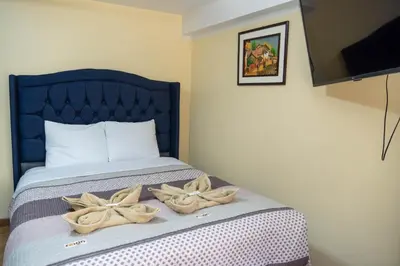 a bedroom with a bed with two bows on it at Conquistador Hotel in Cusco