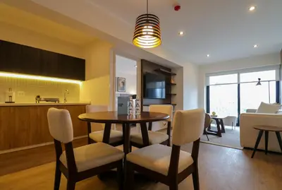 a kitchen and dining room with a table and chairs at Liven in Miraflores by Wynwood House in Lima
