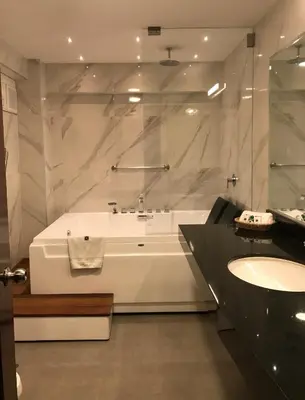 a white bathroom with a tub and a sink at Hotel Lexus in Lima